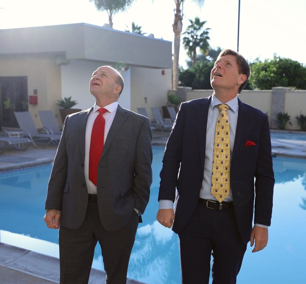 Nate Armstrong and Chris Lavin standing by the pool at a Home Invest community